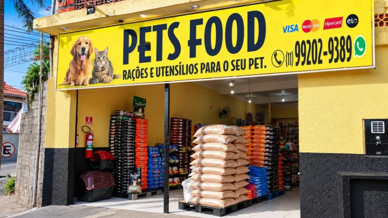 Fachada amarela da Casa de Ração Pets Food, com entrada e produtos para animais, em São Pedro.